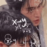 a man and a woman looking at a chalkboard with math equations on it