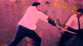 a man in a white jacket is holding a sword in front of a wall that says " caution " on it