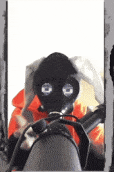 a person wearing a gas mask with smiley faces on them