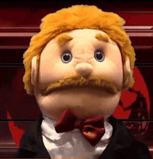 a close up of a puppet with a mustache and a bow tie