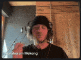 a man wearing headphones with the name karakoram mekong on the bottom right