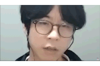 a close up of a person wearing glasses and earphones .