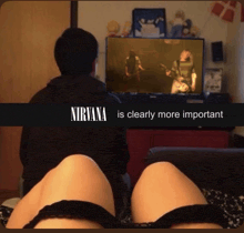 a man and a woman are watching a nirvana video