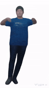a man in a blue shirt and black pants is pointing at the camera