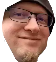 a man with glasses and a beard is smiling for the camera