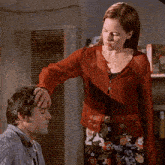 a woman is touching a man 's forehead with the words your head is moist