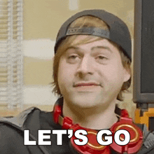 a man wearing headphones says let 's go in white letters
