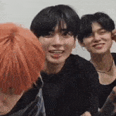 a group of young men with red hair are sitting next to each other and smiling .