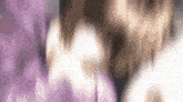 a blurred image of a person 's face with a purple background .