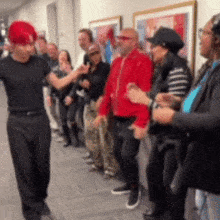 a man with red hair stands in front of a crowd of people