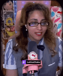 a woman with glasses and a hello kitty microphone says latinaotaku on it