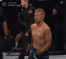 a man without a shirt is in a boxing ring with a monster energy sign behind him