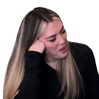 a woman with long blonde hair holds her hand to her forehead