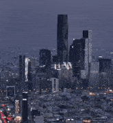 an aerial view of a city at night with a few buildings including one that says ' abc ' on it