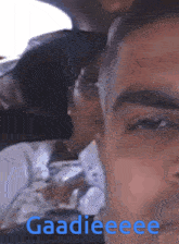 a close up of a man 's face with the words gaadieeee written on it