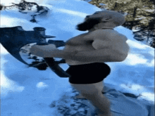 a shirtless man holding a large axe in the snow