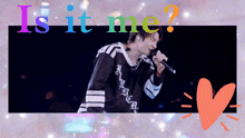 a man singing into a microphone with the words is it me
