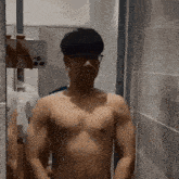 a shirtless man is taking a picture of himself in the mirror