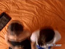 a man and a woman are sitting on a bed with the words pisau cukur written on the bottom