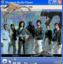 a windows media player screen shows a group of people and an alien