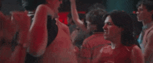 a woman is screaming in a crowd of people at a party .