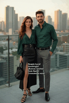 a man and a woman are posing for a picture and the woman is wearing a green shirt and the man is wearing grey pants