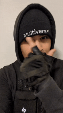 a person wearing a black beanie with the word multivers on it