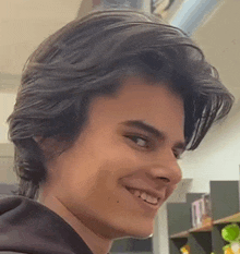 a close up of a young man 's face smiling .