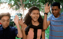 a group of young people are waving at the camera