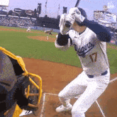 a baseball player wearing a dodgers jersey is getting ready to bat