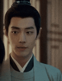 a close up of a man wearing a kimono