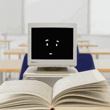 a hp computer is sitting on top of a stack of books