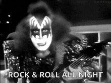 a black and white photo of a man playing a guitar with the words `` rock & roll all night '' .