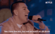 a man singing into a microphone with the words " yes i love the mic but not as much as jill scott " above him