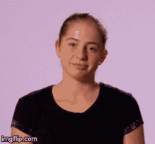 a woman in a black shirt is making a funny face with imgflip.com written below her