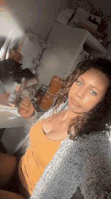 a woman taking a selfie with a bottle of dove lotion