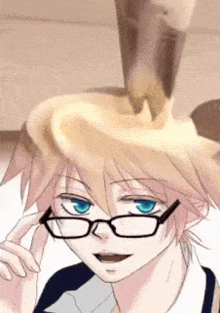 a boy with glasses is looking at something that is pouring on his head