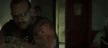 a group of men are standing next to each other in a dark room holding guns .