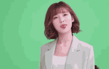 a woman with short hair is wearing a suit and making a funny face