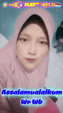 a woman wearing a pink hijab with the words assalamualaikum wr wb below her