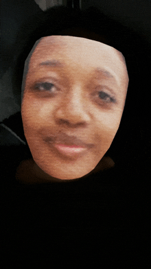 a close up of a woman 's face against a dark background
