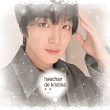 a close up of a person 's face with the words `` haechan de kristina '' on it .
