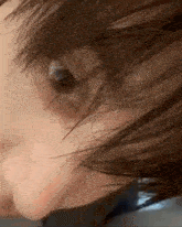a close up of a person 's face with their hair blowing in the wind .