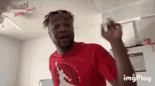 a man wearing a red t-shirt that says " tigers run " on it