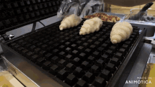 three croissants are being cooked on a waffle maker with the words made in animotica on the bottom
