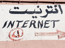 a sign on a wall that says internet and has an arrow pointing to the right