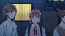 a group of girls are standing in front of a window