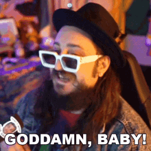 a man wearing sunglasses and a hat says " goddamn baby "