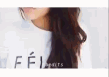a woman with long hair is wearing a white shirt that says ffi