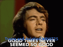 a man singing into a microphone with the words good times never seemed so good
